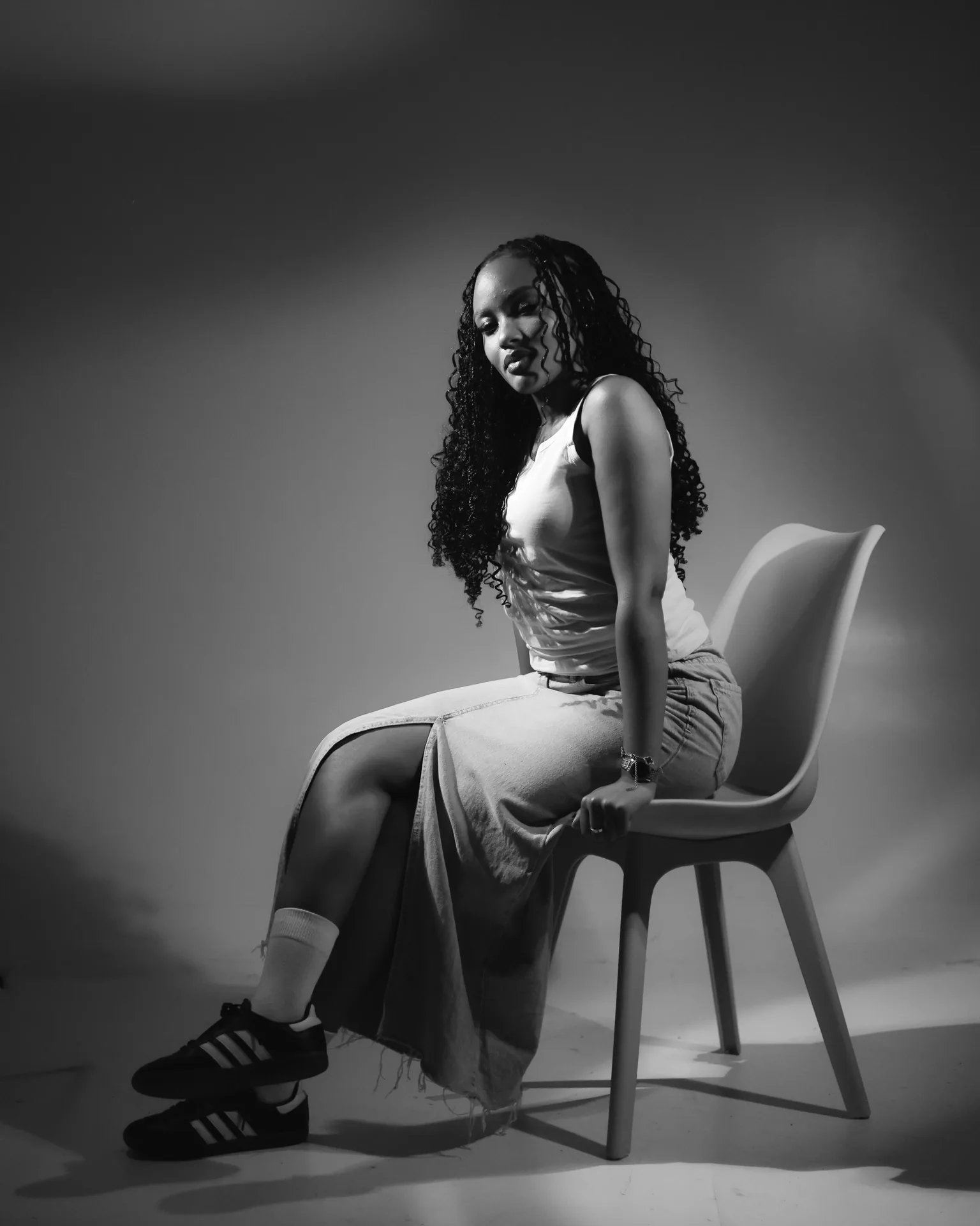 Black-and-white portrait of Tipilda seated on a chair